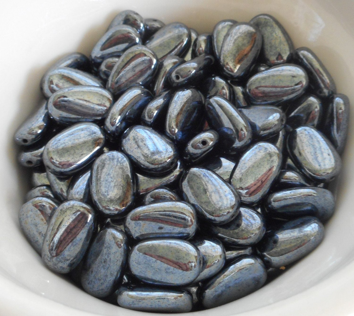 Lot of 25 Metallic Gray Hematite slightly twisted oval Czech Glass beads, 14mm x 8mm pressed glass beads C3225 - Glorious Glass Beads