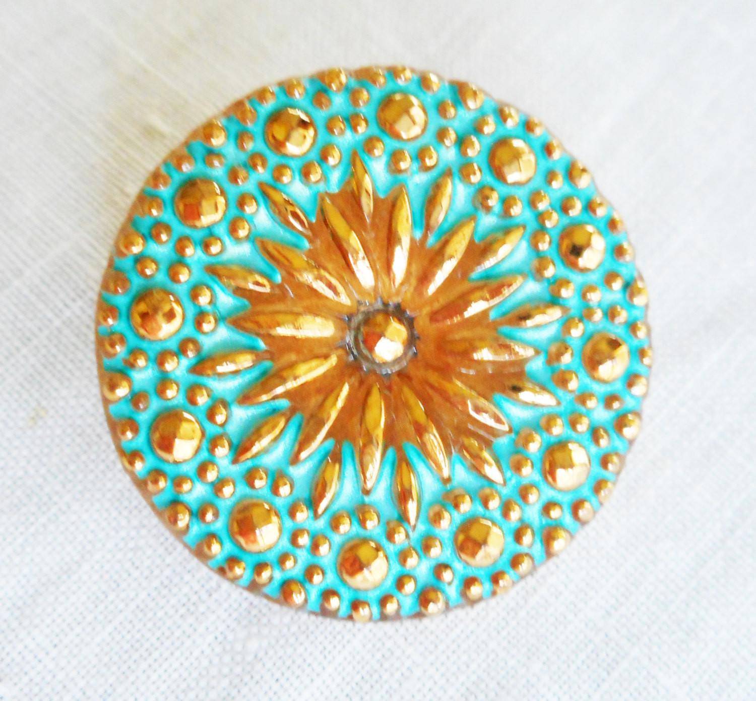 One 22mm Czech glass button, gold starburst with a green turquoise wash, verdigris look decorative shank button 52301 - Glorious Glass Beads