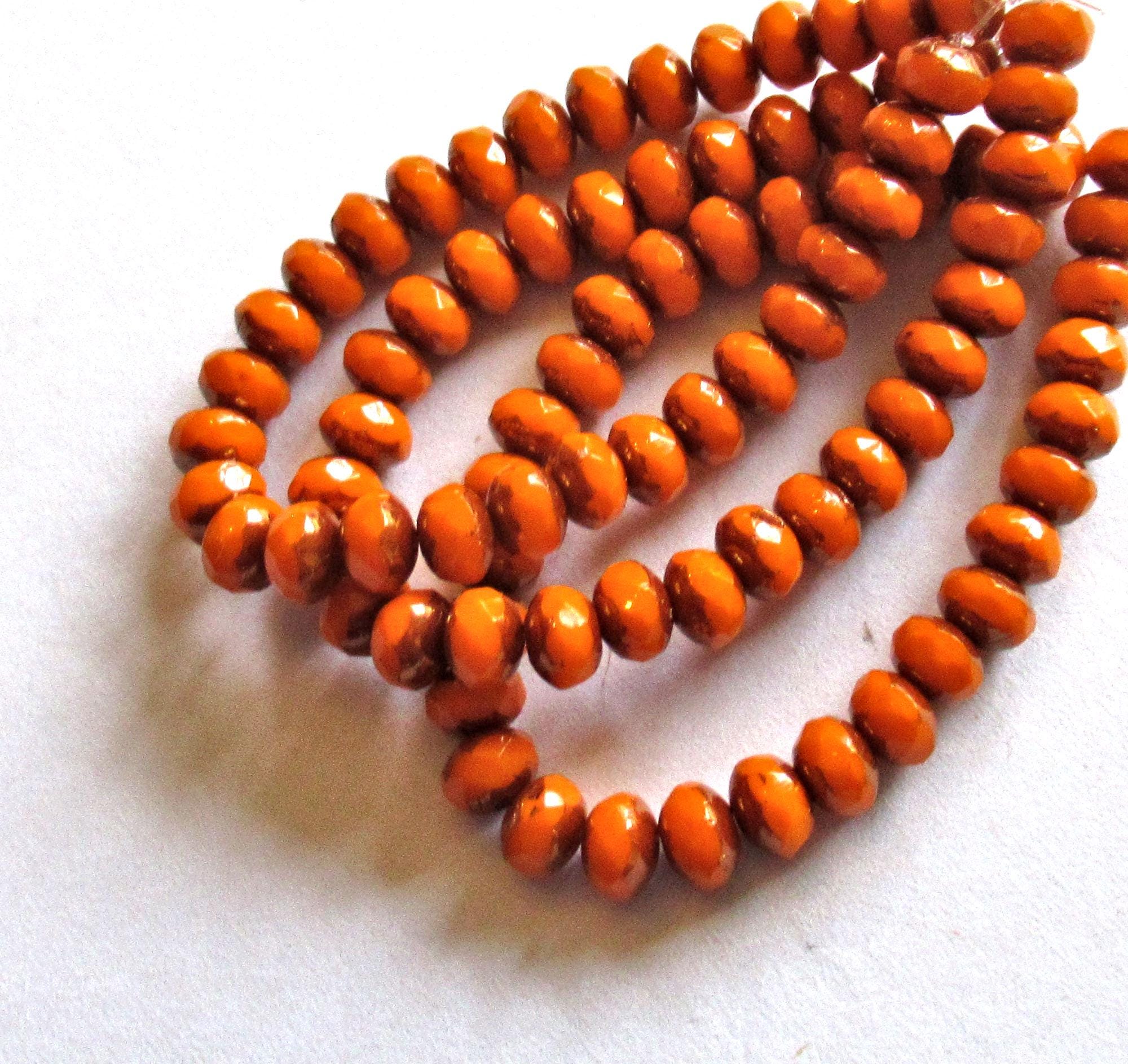 30 small Czech glass puffy rondelle beads - 3mm x 5mm - opaque bright pumpkin orange w/bronze accents - 00041