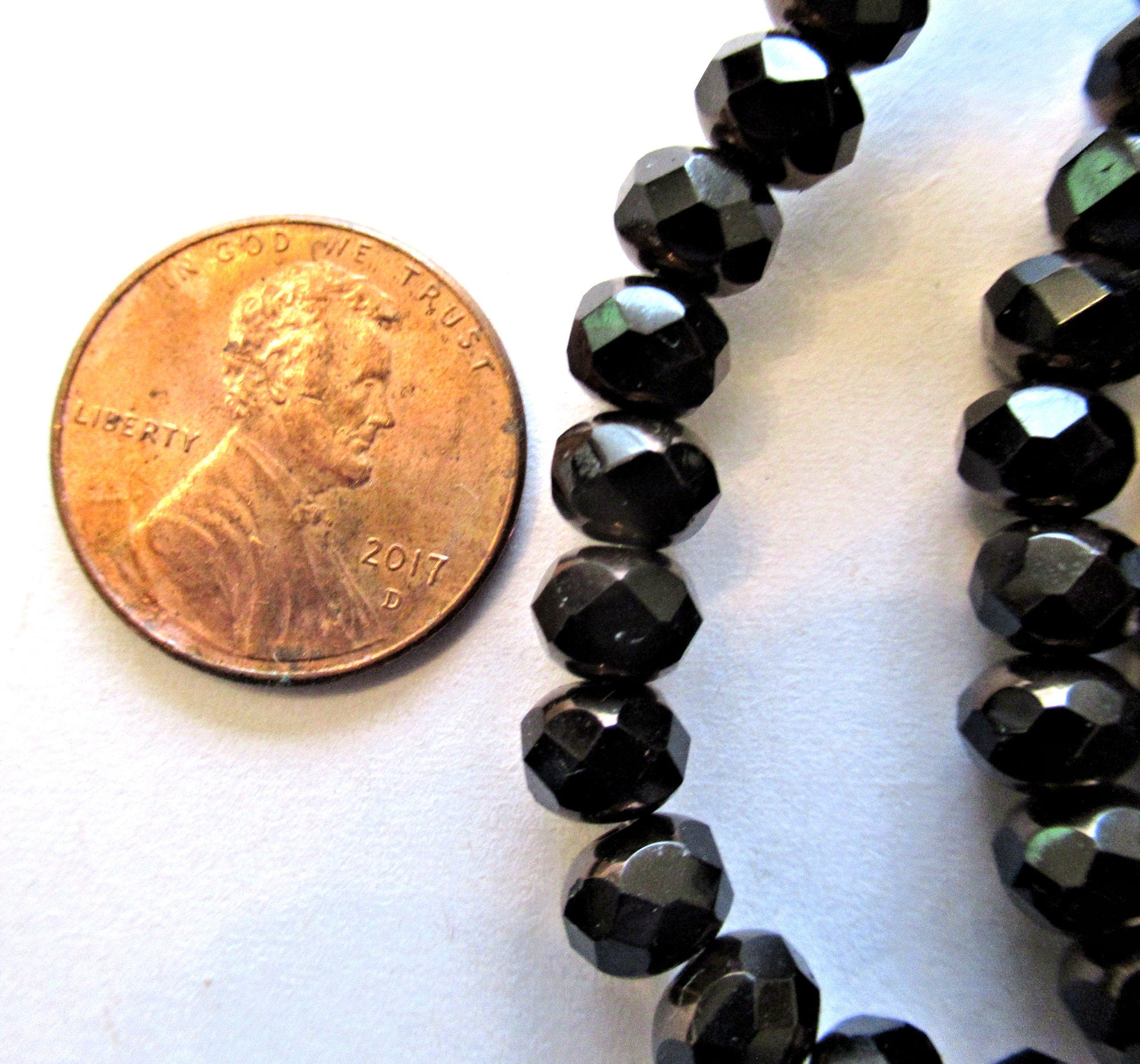 25 Czech glass puffy rondelle or donut beads - 5 x 7mm jet black beads w/ bronze finish on the ends - fire polished faceted rondelles 00612
