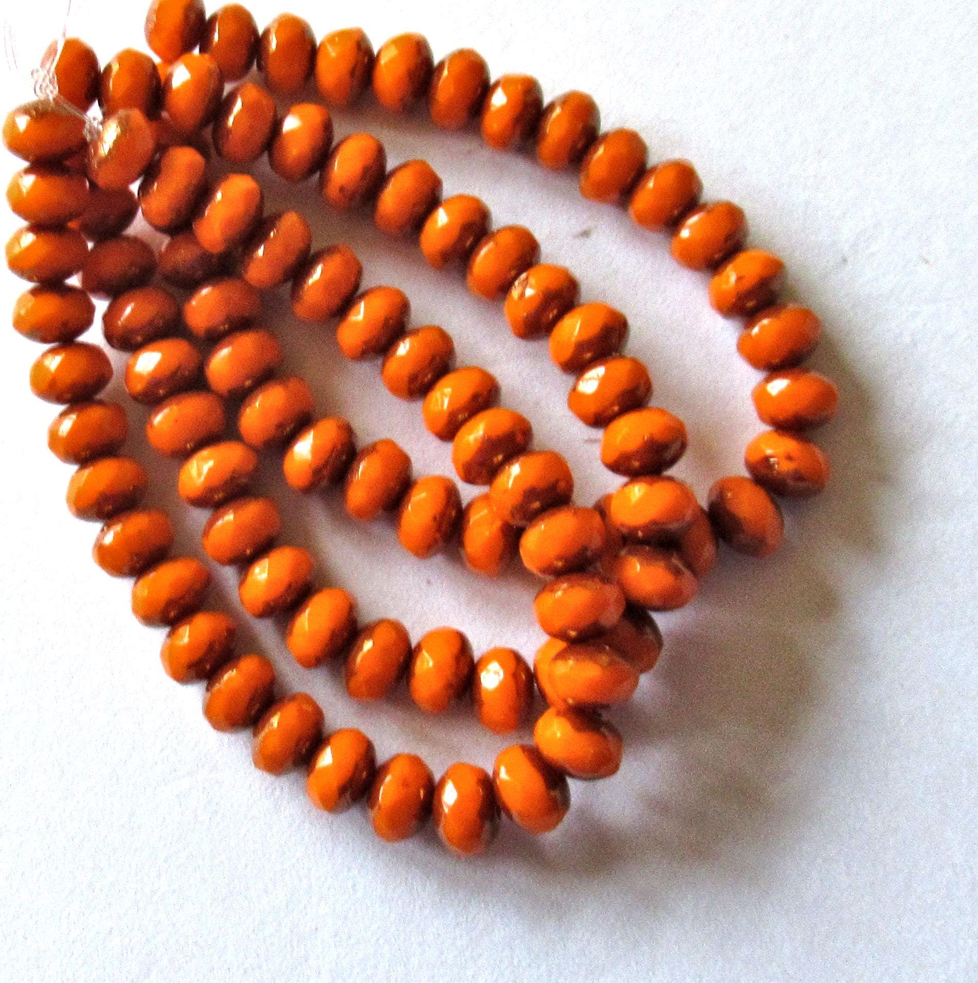 30 small Czech glass puffy rondelle beads - 3mm x 5mm - opaque bright pumpkin orange w/bronze accents - 00041