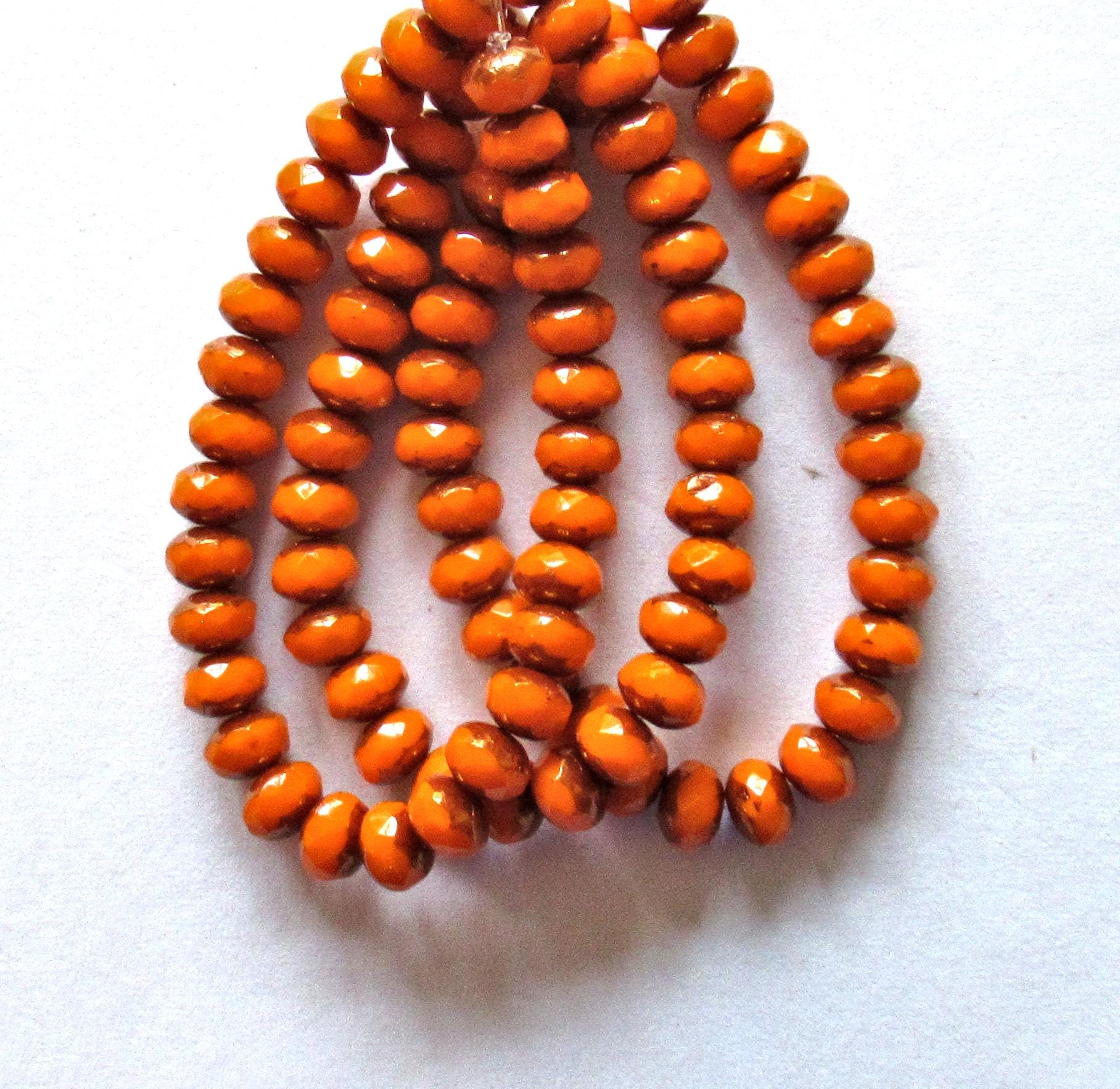 30 small Czech glass puffy rondelle beads - 3mm x 5mm - opaque bright pumpkin orange w/bronze accents - 00041