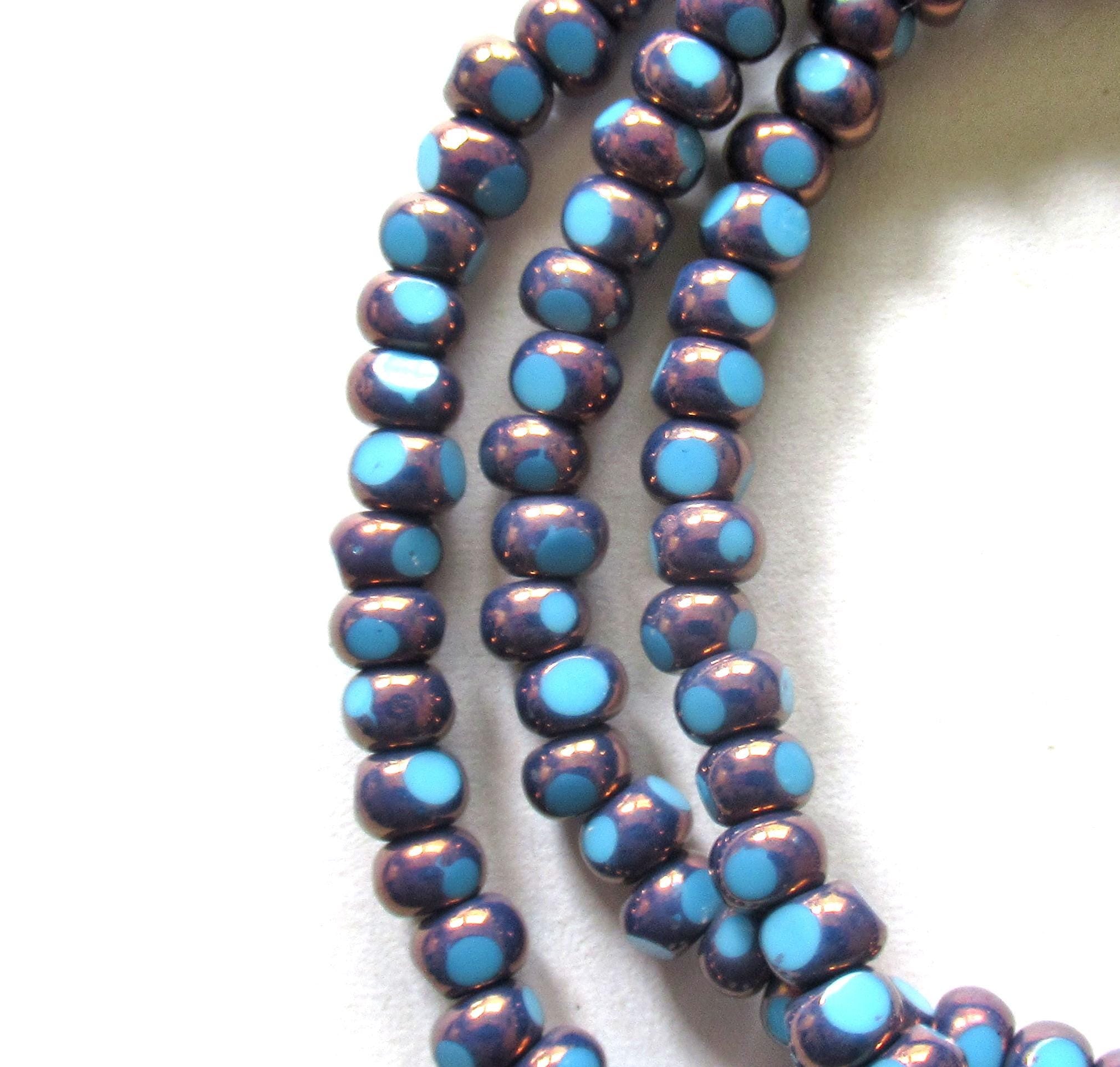 Fifty 6/0 tri cut faceted Czech glass seed beads - opaque light turquoise blue w/ purple bronze accents - C00331