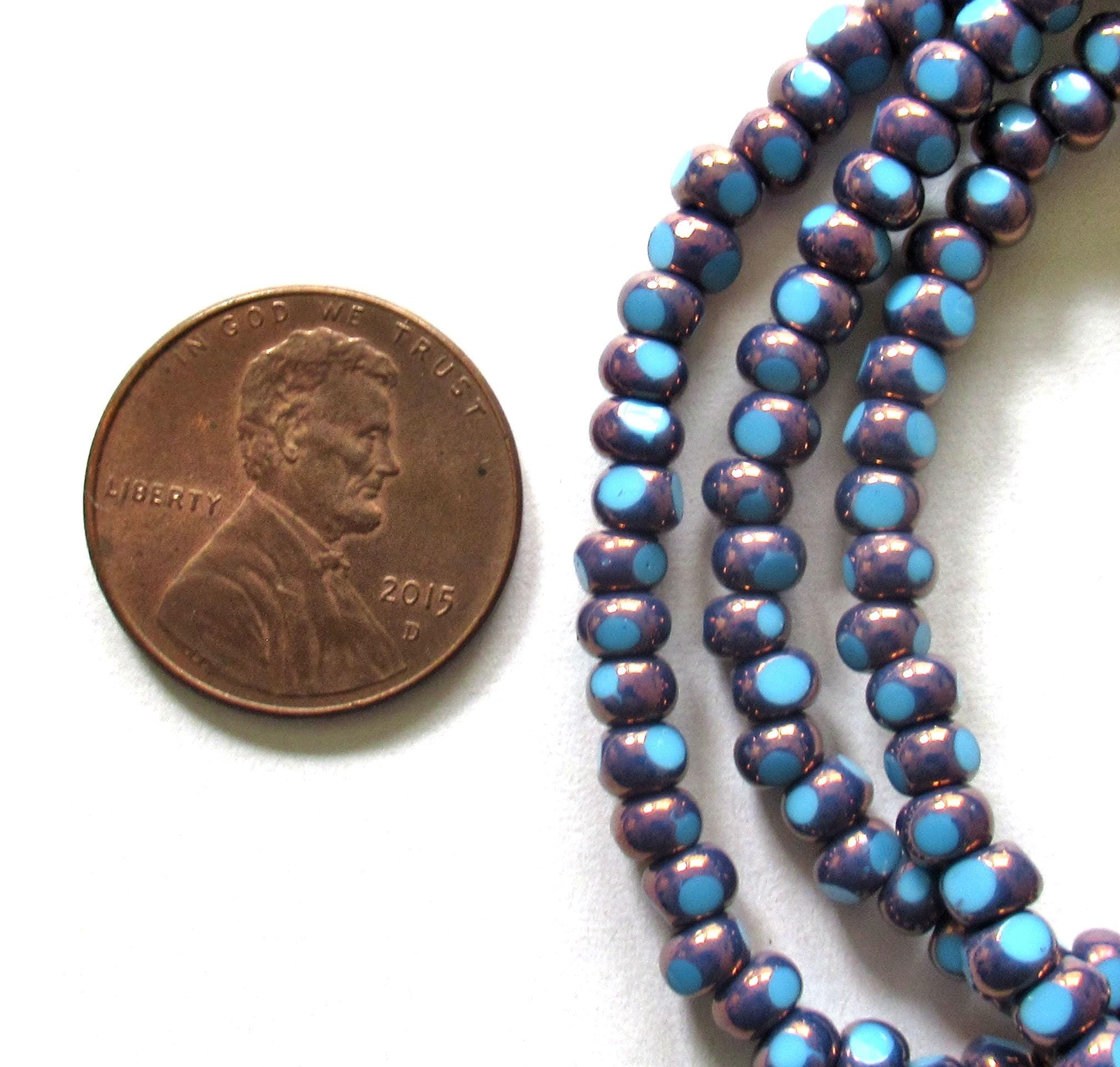 Fifty 6/0 tri cut faceted Czech glass seed beads - opaque light turquoise blue w/ purple bronze accents - C00331