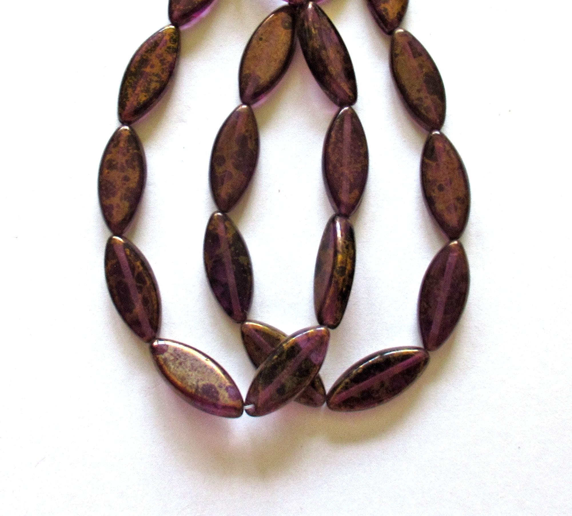 Ten Czech glass spindle beads - 18mm x 7mm - amethyst or purple with a splotchy bronze finish - table cut beads C00522