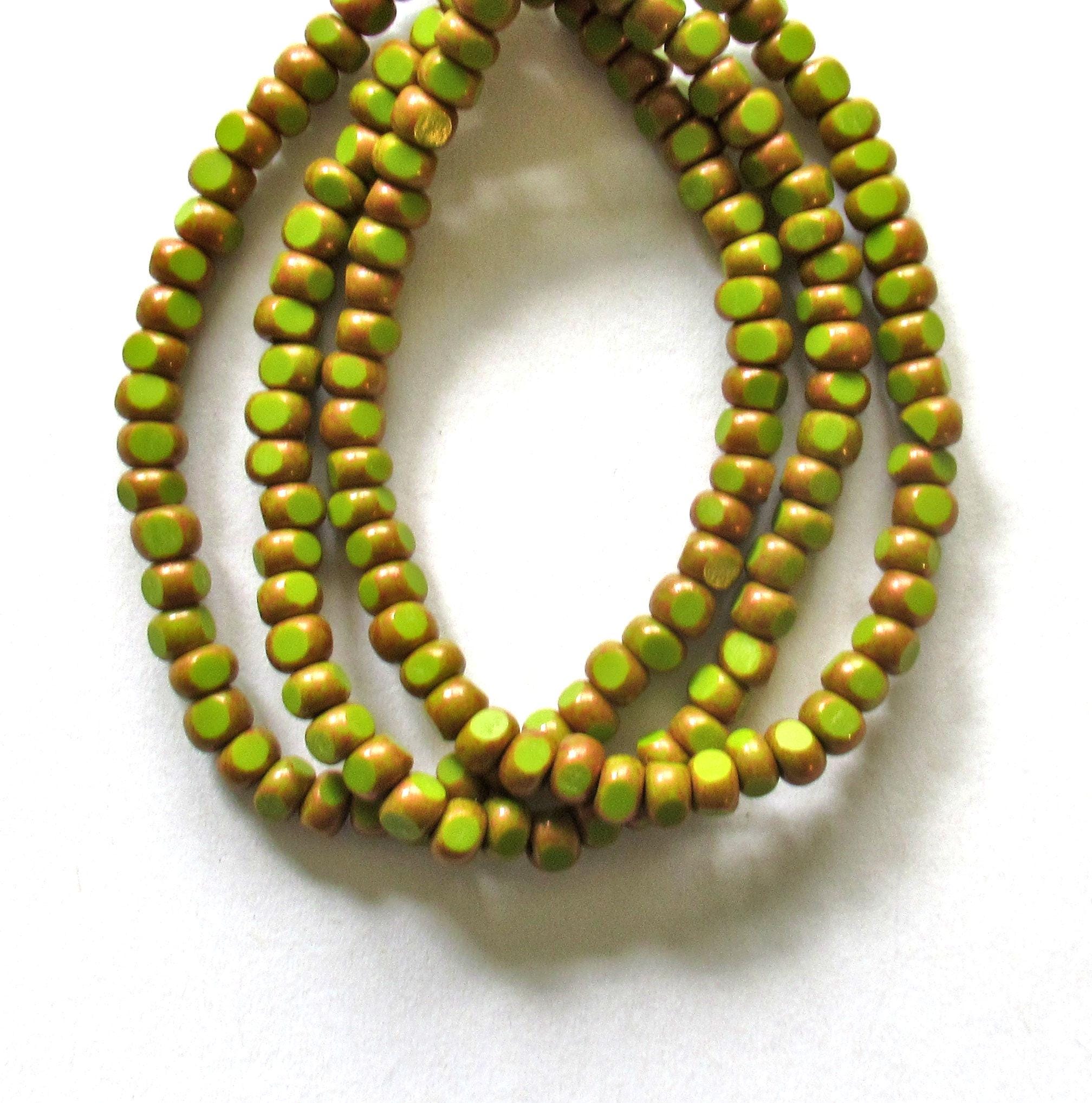 Fifty 6/0 tri cut faceted Czech glass seed beads -opaque avocado green with antique copper accents - C00141