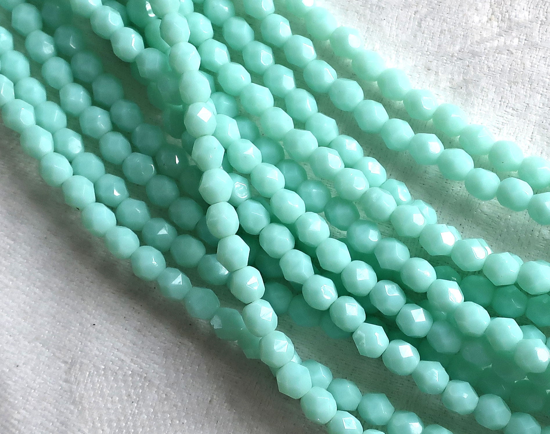 Lot of 50 4mm Opaque Pale Jade Green Czech glass beads, opaque light green faceted. firepolished round beads C8501 - Glorious Glass Beads