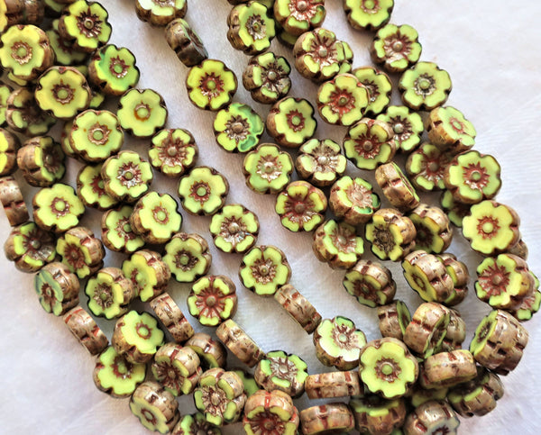 Ten Czech glass flower beads, 10mm opaque yellow green Hawaiian flowers with brown picasso accents, table cut, carved floral beads C10101