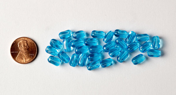 25 9mm x 6mm Aqua Blue Czech glass small twisted oval beads C0076