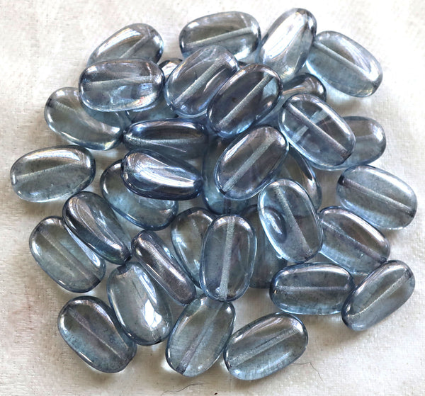 Lot of 25 transparent Lumi Blue slightly twisted oval Czech Glass beads, 14mm x 8mm pressed glass beads C0008