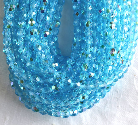 Lot of 50 4mm Aqua Blue AB Czech glass beads, firepolished faceted round beads C8501 - Glorious Glass Beads