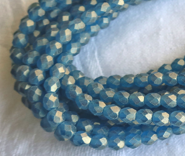 Lot of 50 4mm Sueded Gold Capri Blue Czech glass beads, firepolished, faceted round beads, with a frosty gold finish , C9625 - Glorious Glass Beads