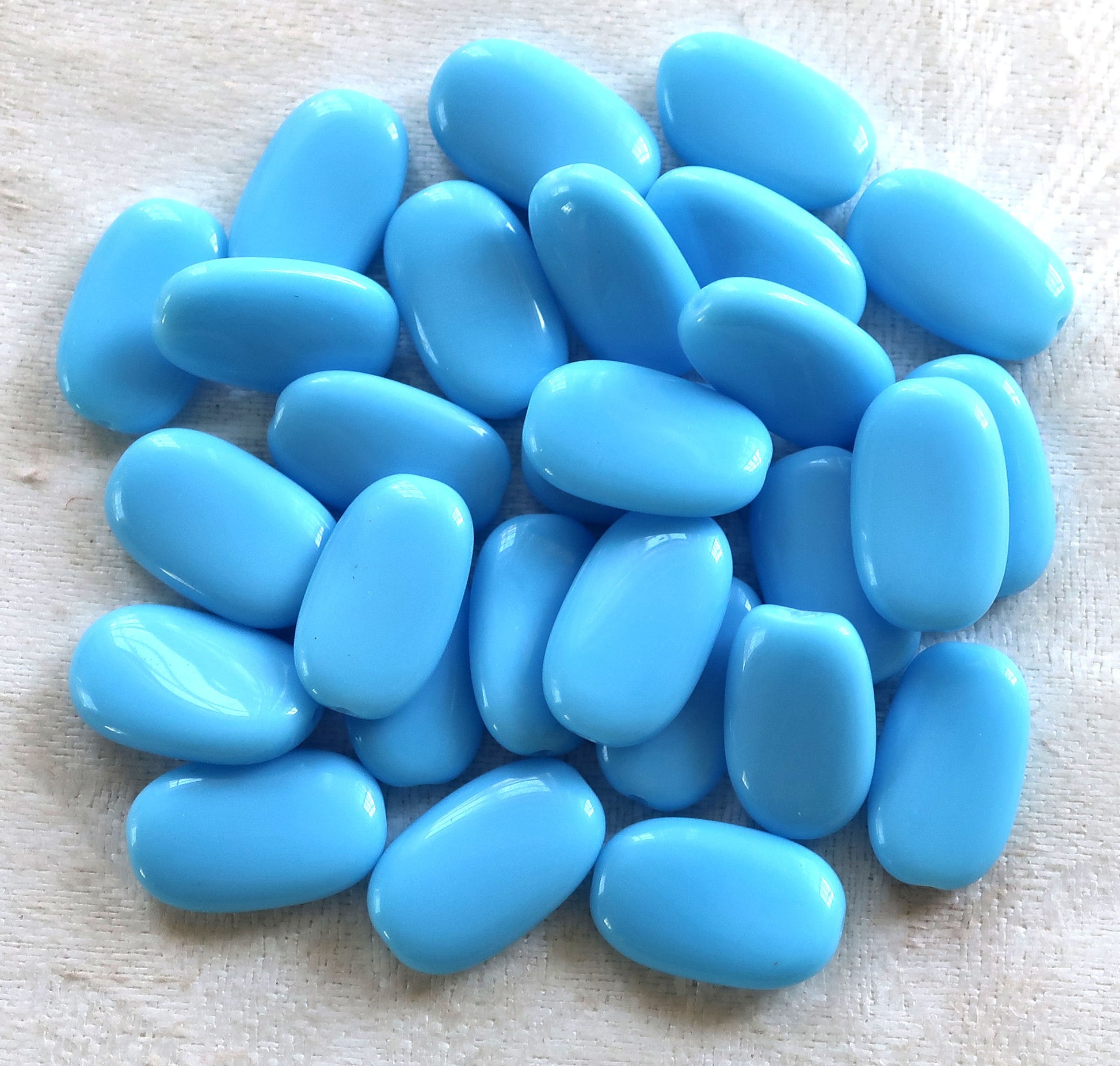 Lot of 25 opaque Turquoise Blue slightly twisted oval Czech Glass beads, 14mm x 8mm pressed glass beads C8925 - Glorious Glass Beads