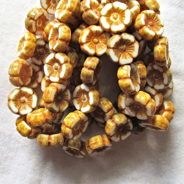 Twelve Czech glass flower beads - 12mm table cut, carved, opaque white Hawaiian flower beads with a golden brown picasso finish C31201