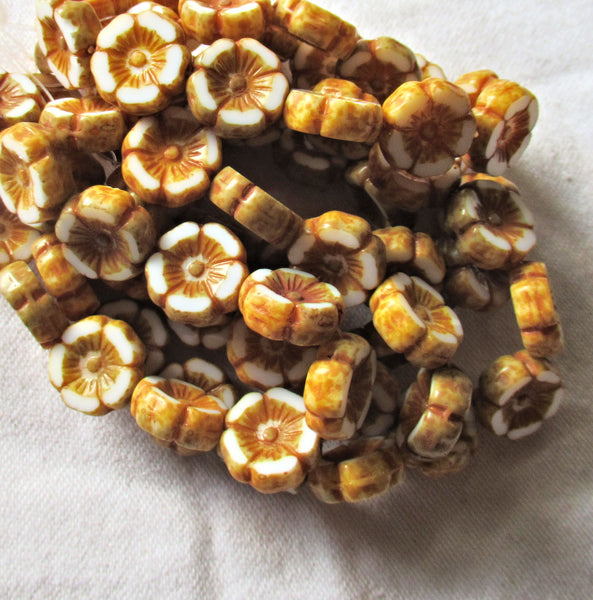 Twelve Czech glass flower beads - 12mm table cut, carved, opaque white Hawaiian flower beads with a golden brown picasso finish C31201