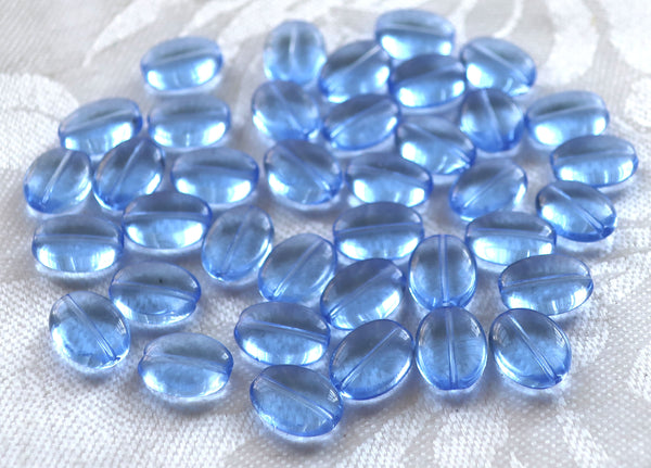 25 transparent light sapphire blue flat oval Czech Glass beads, 12mm x 9mm pressed glass beads C6425 - Glorious Glass Beads