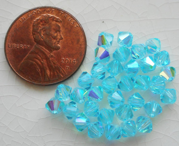 Lot of 24 4mm Aqua blue AB Czech Preciosa Crystal bicone beads, faceted glass blue AB bicones C5601 - Glorious Glass Beads