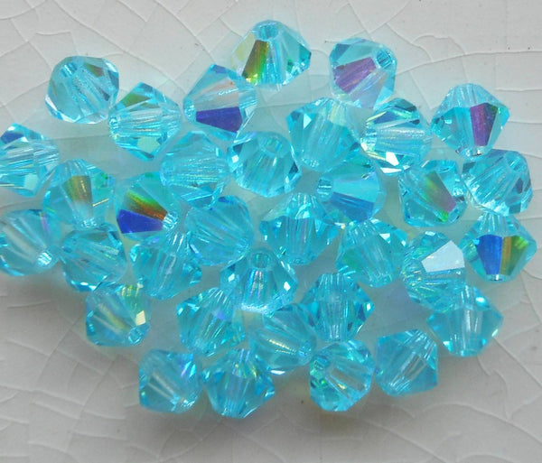 Lot of 24 4mm Aqua blue AB Czech Preciosa Crystal bicone beads, faceted glass blue AB bicones C5601 - Glorious Glass Beads