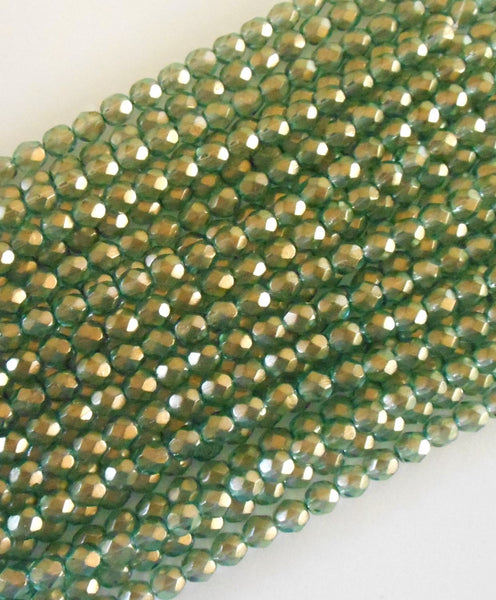 Lot of 25 6mm Halo Heavens green Czech glass, firepolished, faceted round beads with a transparent gold finish, C2925
