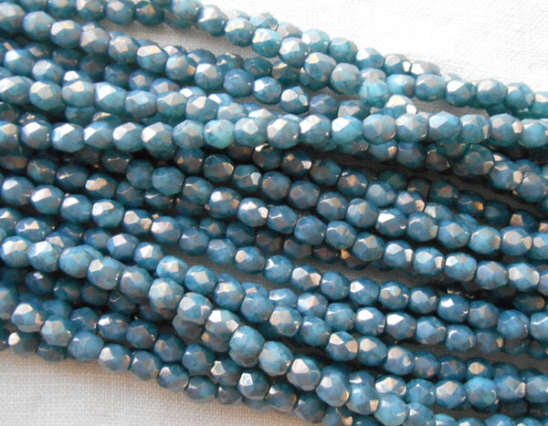 Fifty 3mm Opaque Turquoise Moon Dust Czech glass firepolished, faceted round beads with a golden finish, C0057