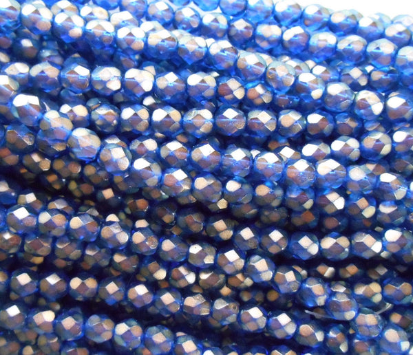 Lot of 25 6mm Halo Ultramarine blue glass, firepolished, faceted round beads with a gold finish, C5525 - Glorious Glass Beads