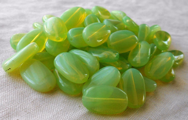 Lot of 25 Light Mint Green Opal slightly twisted oval Czech pressed Glass beads, 14mm x 8mm, C8925 - Glorious Glass Beads
