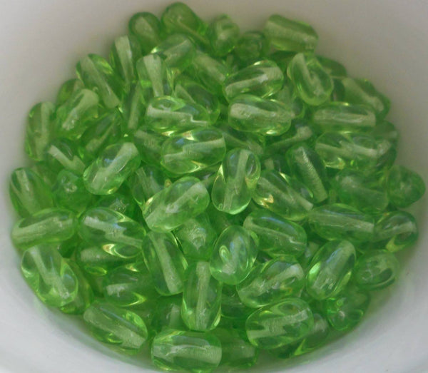 Lot of 25 9mm x 6mm Peridot Lime Green glass twisted oval beads, C7425 - Glorious Glass Beads