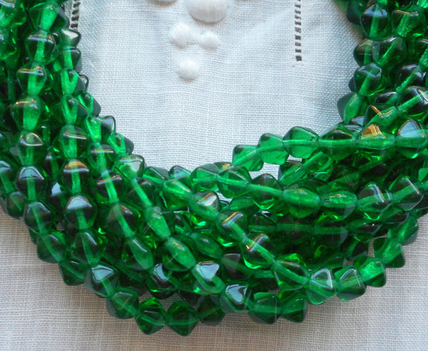 Fifty 6mm Emerald Green bicones, pressed glass Czech bicone beads C5501 - Glorious Glass Beads