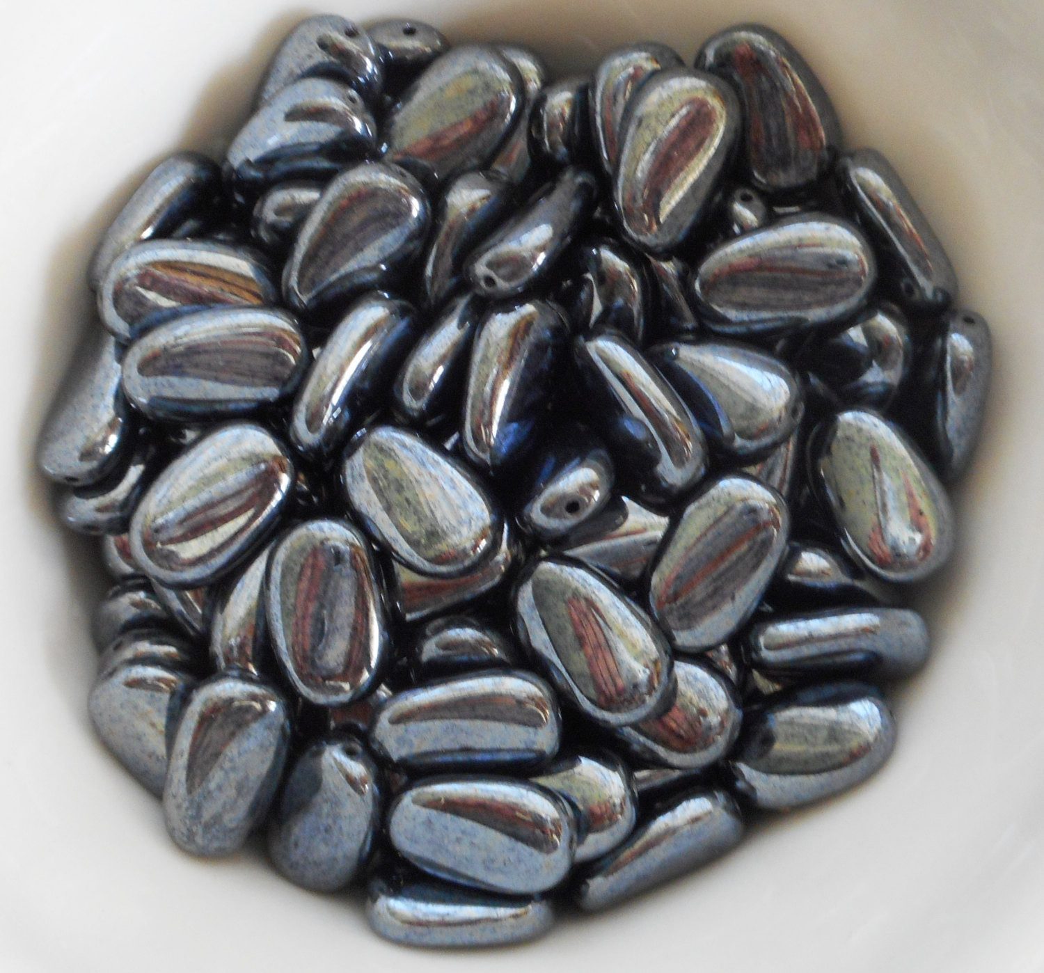 Lot of 25 Metallic Gray Hematite slightly twisted oval Czech Glass beads, 14mm x 8mm pressed glass beads C3225 - Glorious Glass Beads