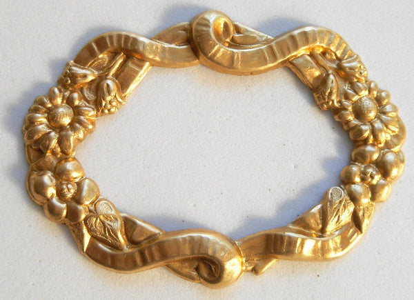 One raw brass stamping, oval frame in flowers and ribbons, pendant, connector, 50 x 35mm, made in the USA, C7501