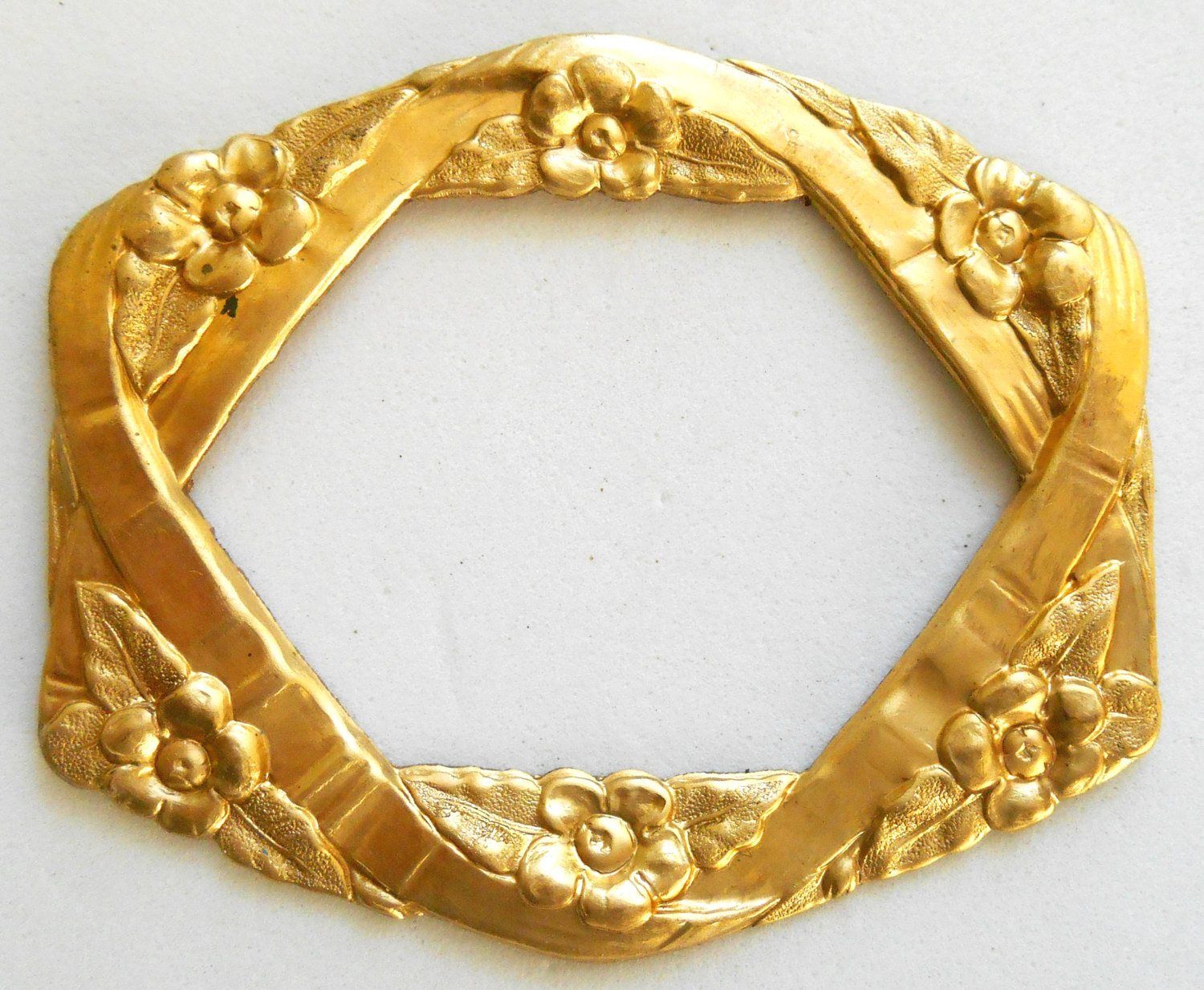 One raw brass stamping, oval frame in flowers and ribbons, pendant, connector, ring, 55 x 46mm, made in the USA, C8601 - Glorious Glass Beads
